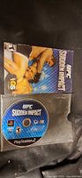 Game disc and manual for UFC Sudden Impact PS2 in sleeve