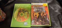 Guitar Hero III case with cover art and disc; partial view of second case