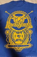 Front view showing full yellow Rock Stars graphic on blue T-shirt