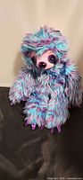 Full view of Build-A-Bear purple blue sloth plush seated