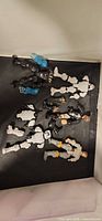 Loose Star Wars Hero Mashers parts scattered on black surface