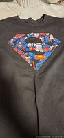 Front of T-shirt showing Superman shield collage graphic