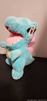 Front angled view of Totodile plush showing overall design and colors