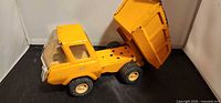 Side view of dump truck with bed raised