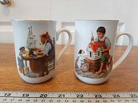 Front view of both mugs displaying Norman Rockwell scenes