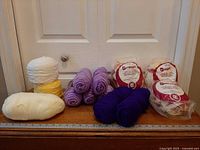 All yarn pieces lined up on a bench with ruler for scale