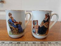 Front view of both mugs showing illustrations