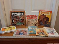 All eight books laid out showing covers and relative sizes