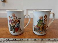 Front view of both mugs showing Norman Rockwell artwork