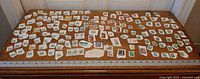 Full tabletop view showing entire assortment of stamps for count verification