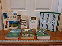 All seven golf books displayed upright and flat