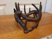 Side view of resin antler holder showing entwined design