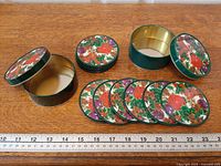 All coasters and both tins displayed with ruler for scale