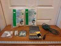 Overview of all items: two filter packs, screwdriver set, wall anchors, extension cord