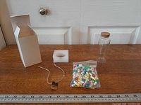 Full kit laid out: box, foam insert, jute tag, bottle, capsule bag