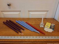 All candles and holder lined beside ruler for scale