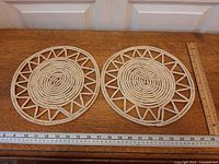 Both woven pads side by side with rulers showing size
