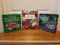Front view of the three gardening books on a shelf