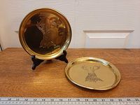 Both brass trays displayed upright and flat to show size and engraving