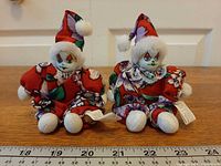 Both porcelain clown dolls with ruler scale