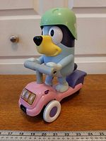 Full view of Bluey figure on scooter