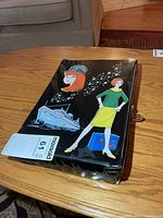 Front view of black Barbie vinyl case with graphic art and MaxSold lot tag