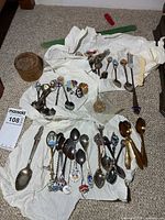 Full lot showing spoons, pins, token and trinket box