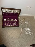 Open chest showing lined interior and utensils arranged in slots