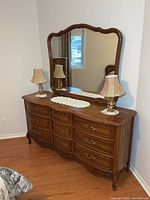 Front view of dresser with mirror attached, lamps on top