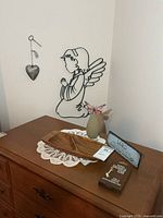 Overview showing angel wall art, heart ornament, tray, vase, plaques