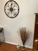 Wall art, twig arrangement, and tealight holder together for scale