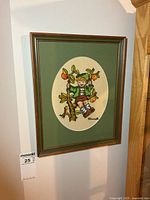 Full view of framed needlepoint hanging on wall