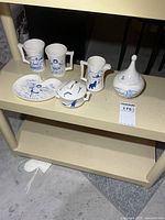Full set of six Inuit motif ceramic pieces displayed on shelf