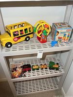 Overall view showing school bus, ferris wheel, boxed puzzle, wooden train and book