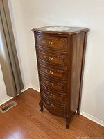 Front view showing six drawers and brass pulls