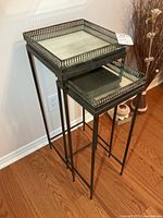 Two metal nesting tables stacked
