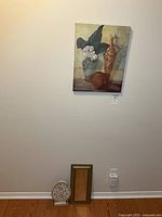Overall lot: canvas on wall, mirror and plaque on floor