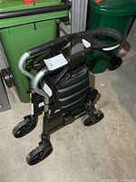 Rollator walker unfolded showing seat, wheels, and handles