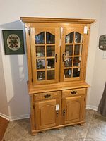 Full view of Canadel oak china cabinet showing upper glass hutch and lower base
