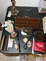 Overall view of desk organizers, figurines, brushes, shoehorn, Sony clock radio, notepad, napkins