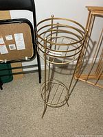 Full view of gold metal plant stand front
