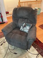 Front view of dark gray microfiber power rocker recliner with accent pillow