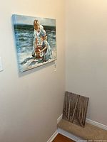 Both canvas prints in corner: beach scene on wall, forest scene leaning