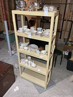 Full view of beige resin shelf with four tiers