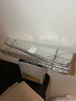 Folded reflective windshield sun shade and boxed seat cover