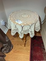 Side table with lace cover, overall view