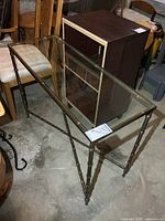 Full view of metal sofa table showing glass top and frame