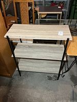 Front view of shelf showing three shelves and frame