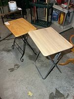 Two side tables side by side showing different bases and tops