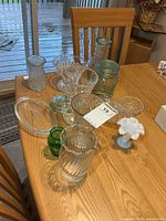 All items on table showing quantity and variety of vases, canister and dishes